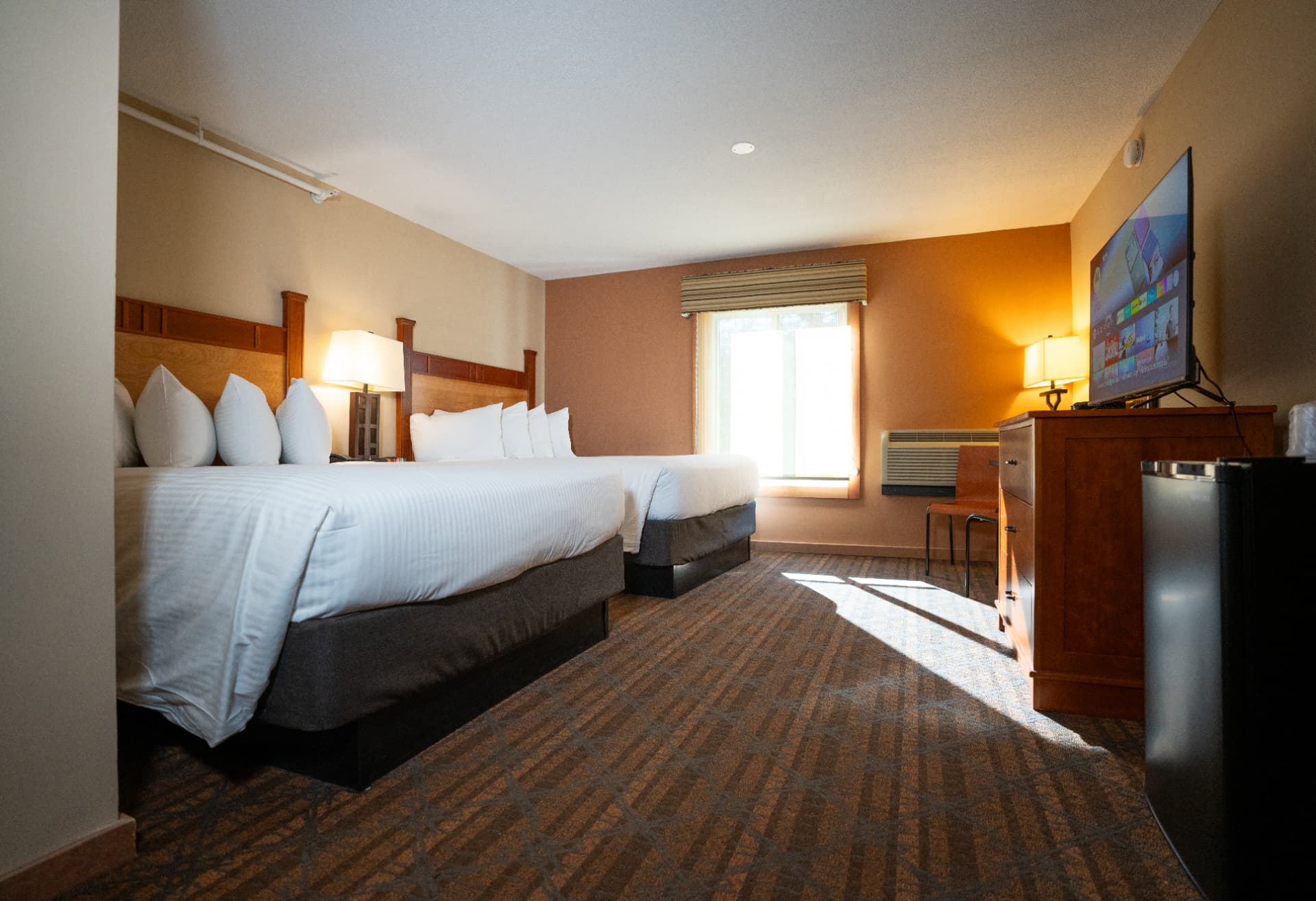 Spacious Black Bear Lodge guest room with two queen beds