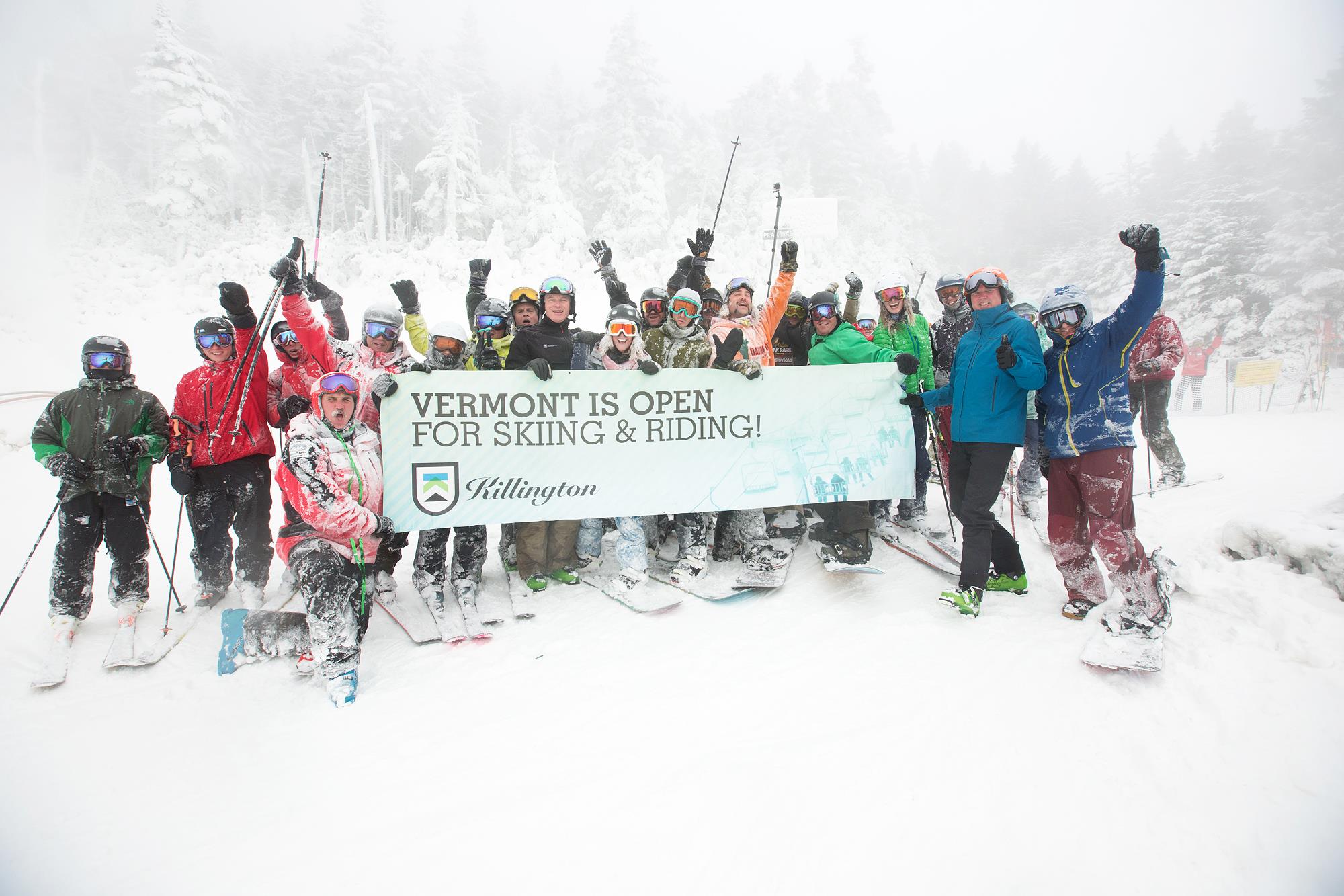 Group of skiers celebrating the Killington season opener in the snow
